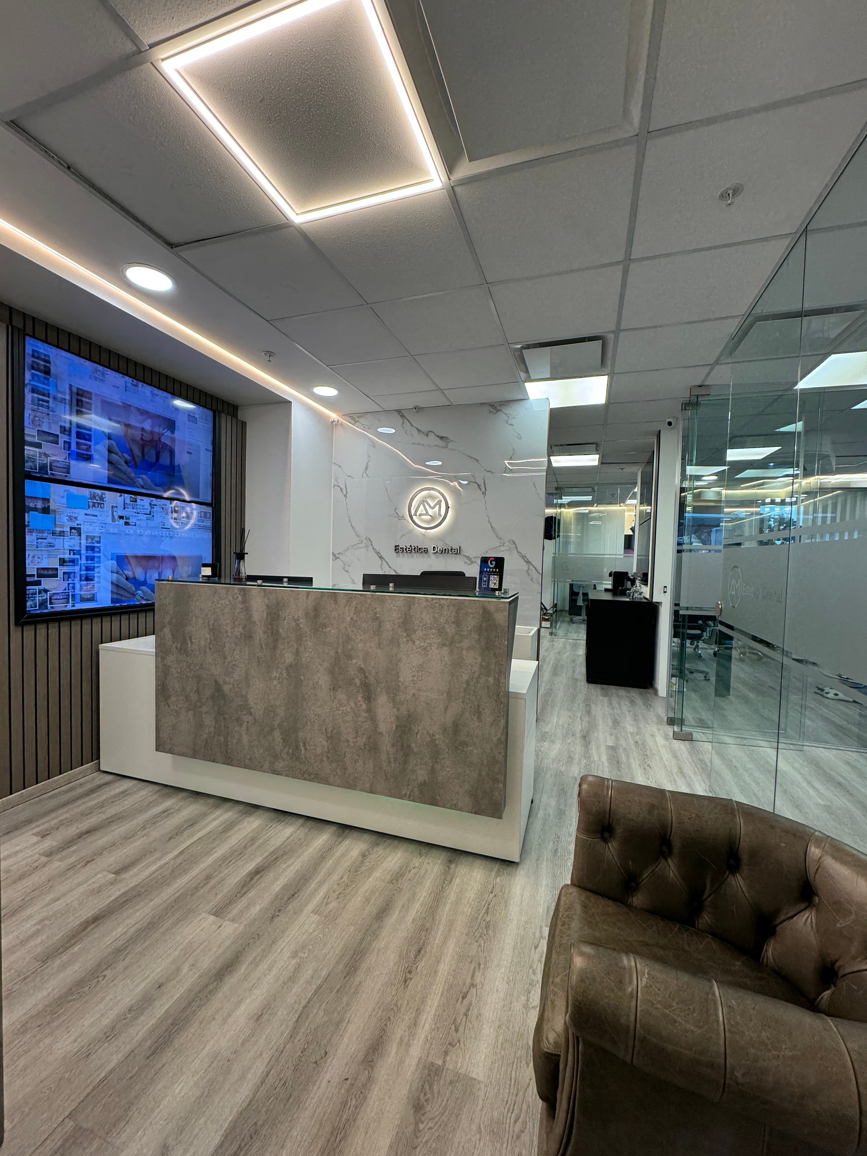 Detalles decorativos en tonos crema y oro de la recepción de AM Estética Dental